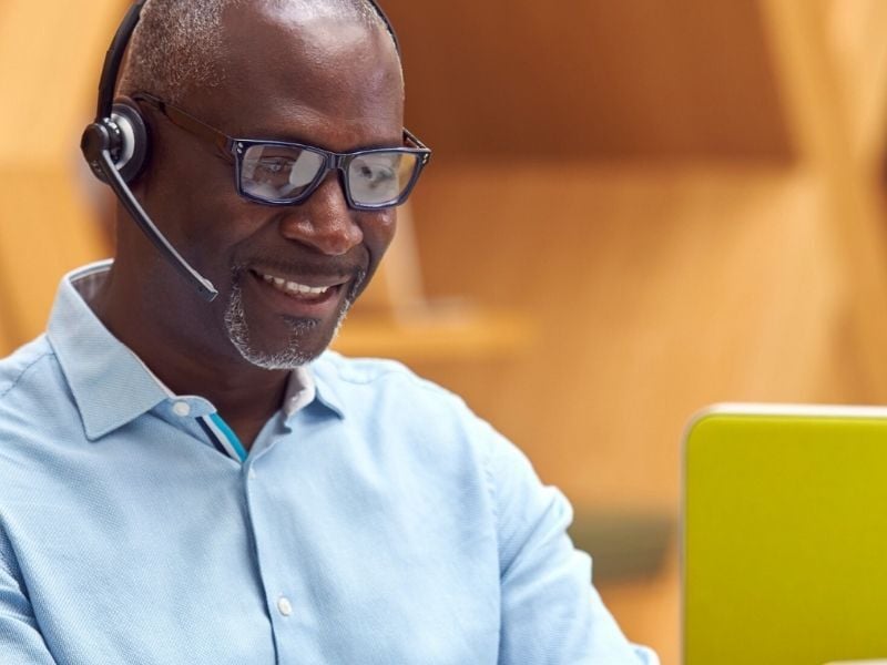 A person wearing a headset and negotiating a contract