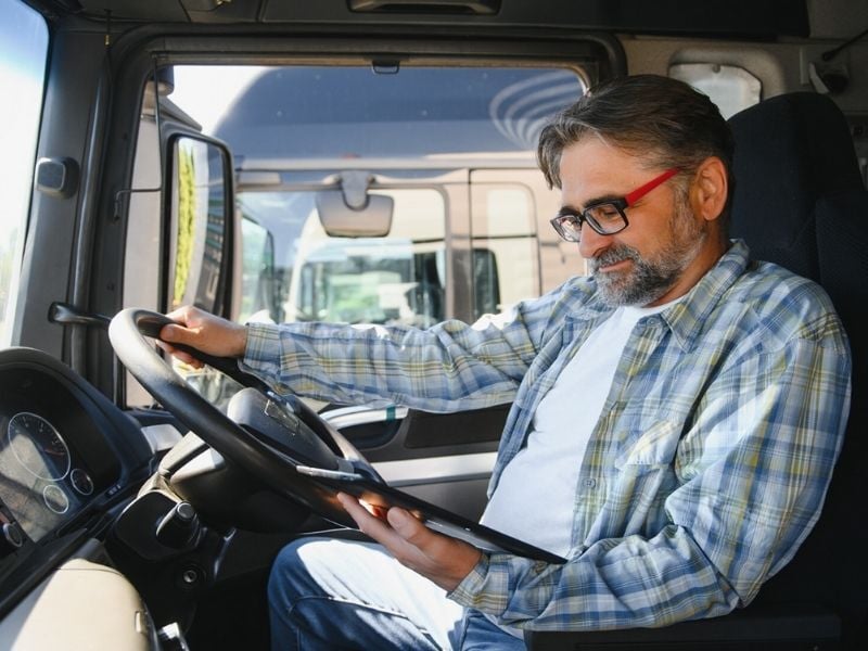 Operations Management_Male trucker driver with tablet