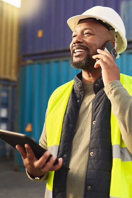 Filed worker using his phone and tablet